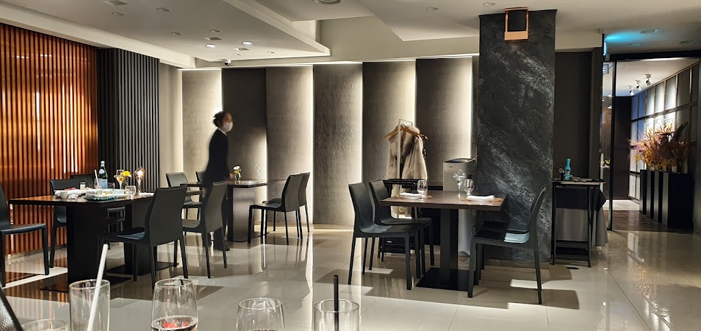 Hidden restaurant interior with chef cooking at open kitchen
